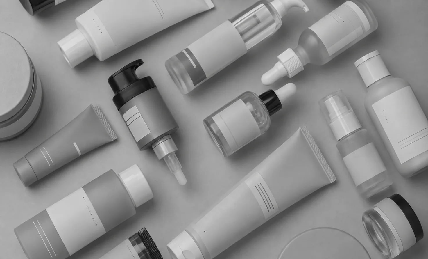 Flat lay of unbranded skincare bottles and tubes