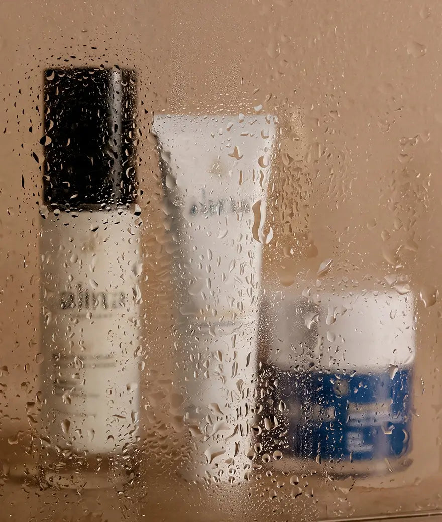 Alina Pro Anti-Aging products behind rain-speckled glass